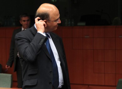 French Finance Minister Pierre Moscovici scratches his head during the Eurogroup meeting