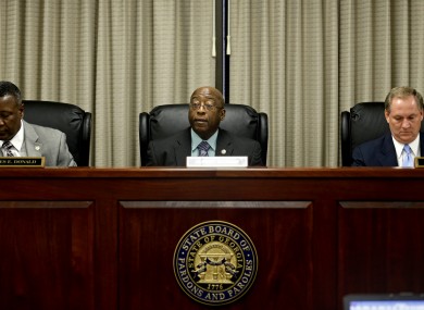 Members of the Georgia Board of Pardons and Paroles, from left, James Donald, Albert Murray, and James Mills,