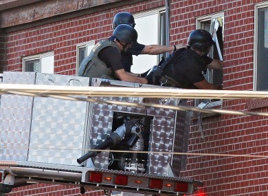 Police use a video camera to look inside an apartment where the suspect in a shooting at a movie theatre lived in Aurora.