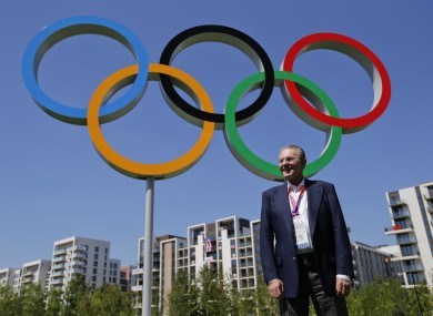 IOC president Jacques Rogge at the Olympic Village. Grindr says the sudden inhabitation of the Olympic Village had nothing to do with its downtime last week.
