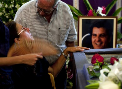 Ofelia Acevedo, the widow of Oswaldo Paya, is commiserated at Paya's funeral in Havana yesterday.