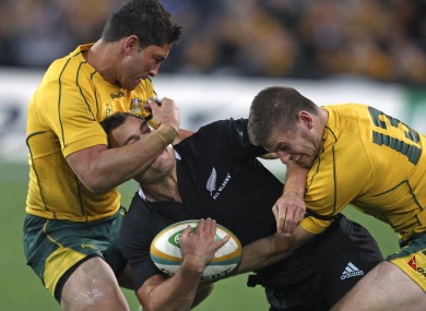 New Zealand's Israel Dagg, center, is tackled by Australia's Anthony Fainga'a, left, and Rob Horne.