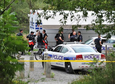 A police team is seen in Hewick Meadows Park in Mississauga, Ont., after discovering a female severed head in the Credit River