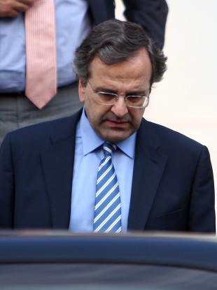 Greece's Prime Minister Antonis Samaras leaves Maximos mansion after his meeting with the other political leaders of the coalition government in Athens.
