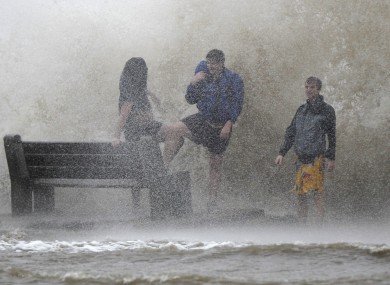 People walk in the storm surge from Hurricane Isaac as the storm approaches landfall in New Orleans.