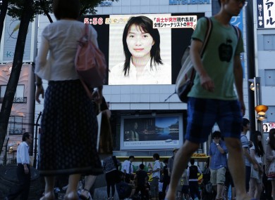A portrait of Mika Yamamoto shown on a large monitor screen in Tokyo today
