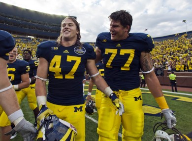 Michigan linebacker Jake Ryan (47) and offensive lineman Taylor Lewan (77) laugh as they walk off the field after an NCAA college football game last weekend.