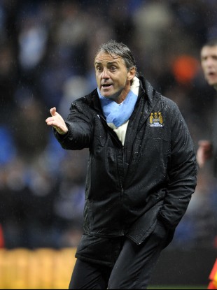 Manchester City's manager Roberto Mancini on the line last night.