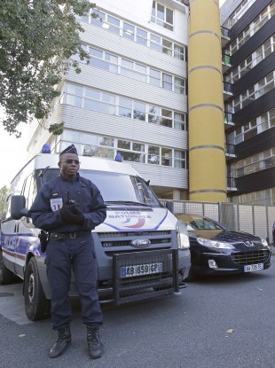 A French policeman stands guard outside the headquarters of the satirical weekly Charlie Hebdo in Paris today.