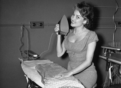 Not the face! French actress Pascale Robert trying to get the hang of this ironing lark in Paris in 1958.