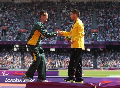 Oscar Pistorius shakes hands with 200m gold medalist Alan Oliveira.