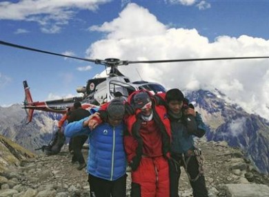 In this photo provided by Nepalese airline Simrik Air, an injured victim of an avalanche is rescued at the base camp of Mount Manaslu in northern Nepal