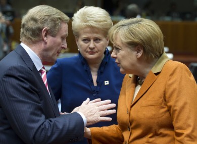Enda Kenny speaking with Angela Merkel during the European Council meeting in Brussels on Thursday. Lithuanian president Dalia Grybauskaite looks on.