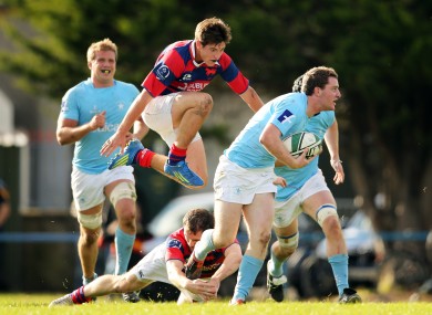 Clontarf's Adrian D'Arcy and Conor Keegan tackle James McInerney of Garryowen.