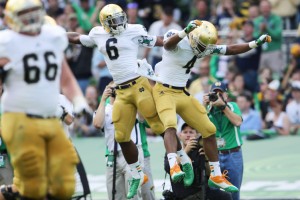 George Atkinson III (left) of Notre Dame celebrates scoring a touchdown with teammate Theo Riddick.