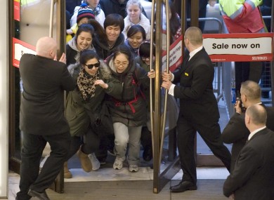 Shoppers rush into Selfridges, on Oxford Street, central London, as the department store opens its doors for the Boxing Day sale last year
