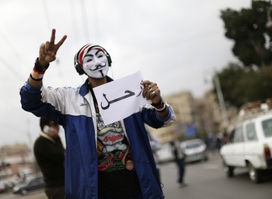 A protester holds a poster that says