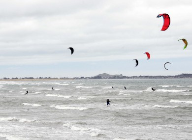 The heavy winds weren't bad news for everyone: kite surfers are seen enjoying the high coastal winds at Dollymount Strand yesterday.