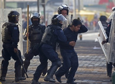 Riot police take away a protestor during clashes around the National Congress, where the swearing in of new Mexican President Enrique Pena Nieto is taking place in Mexico City.