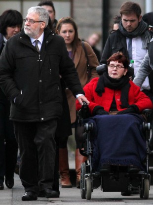Terminally-ill Marie Fleming leaving the High Court in Dublin, with her partner Tom Curran, where has pleaded with judges to spare her a horrible death and let her be helped to die lawfully with dignity.