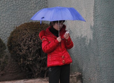 A North Korean woman uses a cellphone on a sidewalk in Pyongyang, North Korea (file photo).