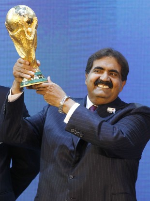 Sheikh Hamad bin Khalifa Al-Thani, Emir of Qatar, holds the World Cup trophy after the announcement of Qatar hosting the 2022 tournament.