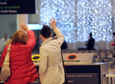 People wave goodbye to family and friends at Dublin Airport as they leave Ireland after the festive break