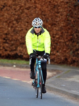 Man City boss Roberto Mancini cycles home from training yesterday.