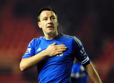 Chelsea's John Terry puts his hand on the club badge as he celebrates his side's victory.