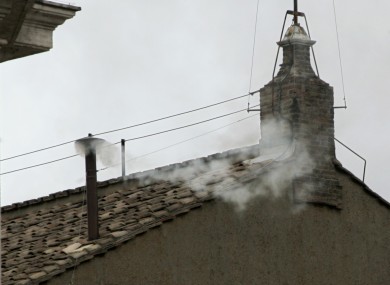 White smoke emerges from the chimney of the Sistine Chapel, indicating a successful outcome to the Papal Conclave of 2005.