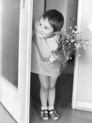 If we were all this cute, it wouldn't matter what we gave - even picked flowers from the garden. Image: Germany, May 1966