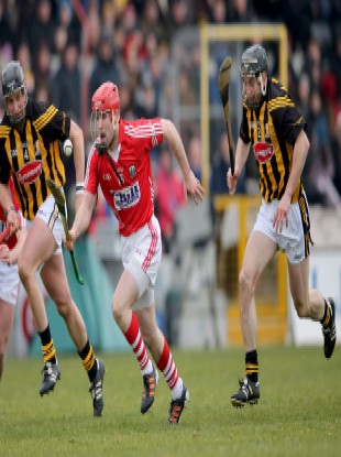 Kilkenny's Jackie Tyrrell and Conor Fogarty chase after Stephen Moylan of Cork.