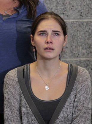 Oct. 4, 2011 file photo Amanda Knox gestures at a news conference in Seattle Tuesday, Oct. 4, 2011, after returning home from Italy.