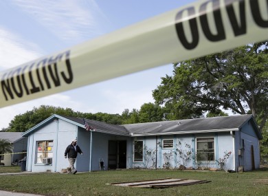 An engineer surveys in front of a home where sinkhole opened up, swallowing Jeff Bush, 37.
