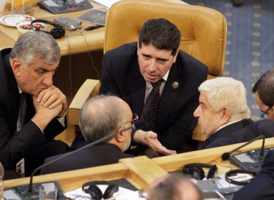 Wael al-Halqi talking with officials at a summit in Iran last year.