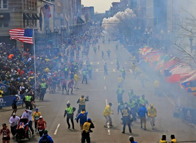 People react as an explosion goes off near the finish line of the 2013 Boston Marathon in Boston, yesterday.