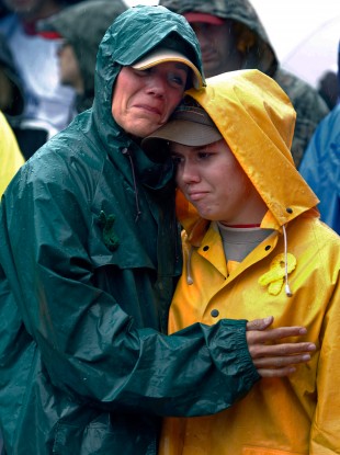 Joan Olsen, left, and her daughter Emily Olsen embrace at the start of the Walk for Suicide Awareness in Kaukauna, Wisconsin. Joan and Emily were honoring Chris Olsen, who was Joan's husband and Emily's father.