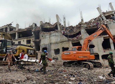 Rescuers carry a body retrieved from the rubble of the eight-story Rana Plaza building that collapsed in Savar, near Dhaka.