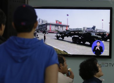 South Koreans watch TV news showing a footage of North Korean missiles on a military parade, at a Seoul Train Station in Seoul,