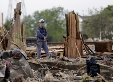 An investigator looks over a destroyed fertilizer plant in West, Texas.