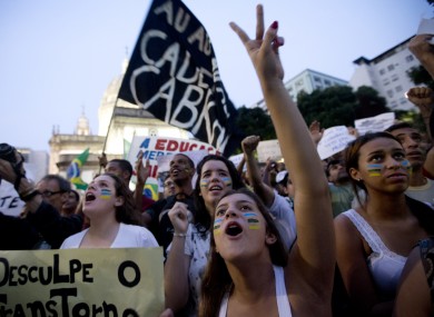 People shout slogans during an anti-government demonstration in Rio de Janeiro, Brazil.