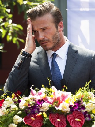 David Beckham wipes his sweat during his speech at a charity event at the Soong Ching Ling Residence in Beijing earlier this week.