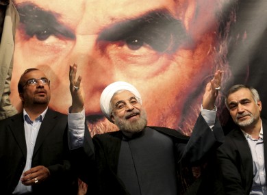 n front of a portrait of the late Iranian revolutionary founder Ayatollah Khomeini, Iran's new president Hasan Rowhani