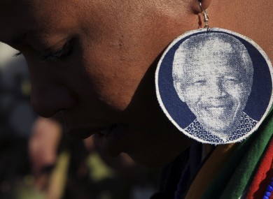 A woman prays for Madiba outside his hospital in Pretoria, SA.