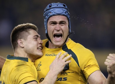 James Horwill celebrates Australia's win with James O'Connor (l)