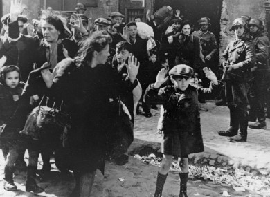 A group of Jewish people are moved from the Warsaw Ghetto by German soldiers on 19 April 1943