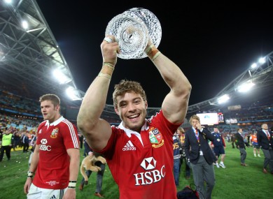 Leigh Halfpenny holds the Tom Richards Trophy aloft.