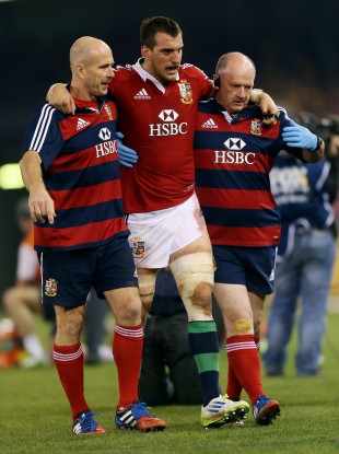 Warburton is helped off the field during the Lions game with Australia.