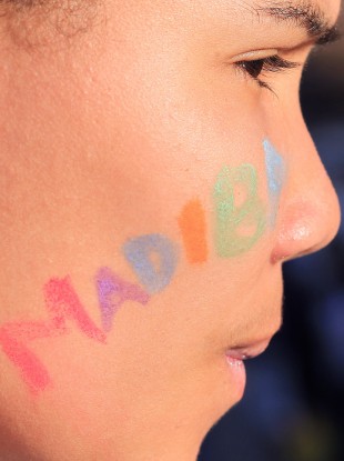 An unidentified girl with her face painted with the word 'Madiba' in reference to Nelson Mandela, stands outside the Mediclinic Heart Hospital where former South African President Nelson Mandela is being treated.
