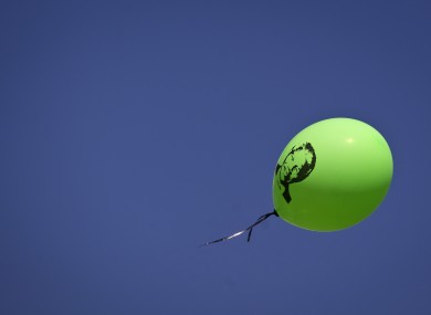 A balloon with the face of Nelson Mandela is released into the sky by a well-wisher outside the Mediclinic Heart Hospital.